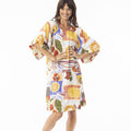 woman wearing an orientique puff sleeve dress in felicia print