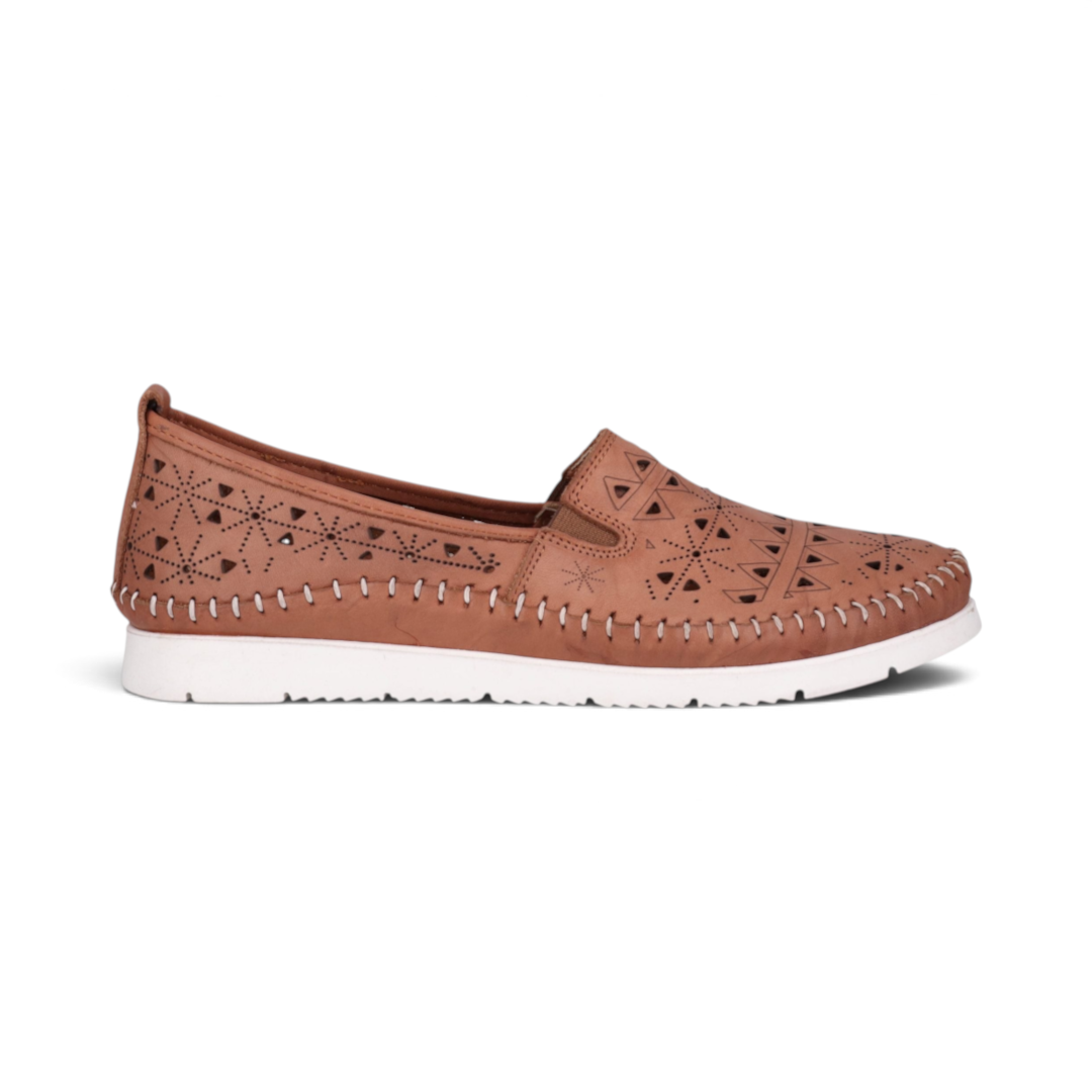 The Happy Shoe Shop Cabello Clear tan leather slip-on loafers with punched geometric patterns and white rubber soles.