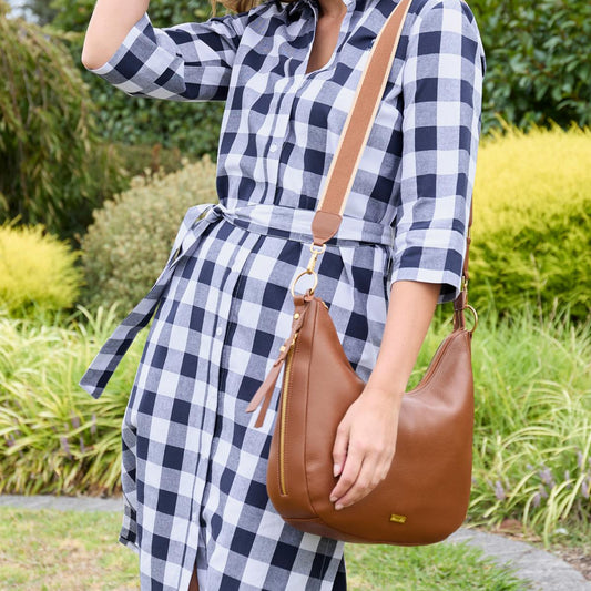 Woman carrying brown leather Thomas Cook Nadia handbag