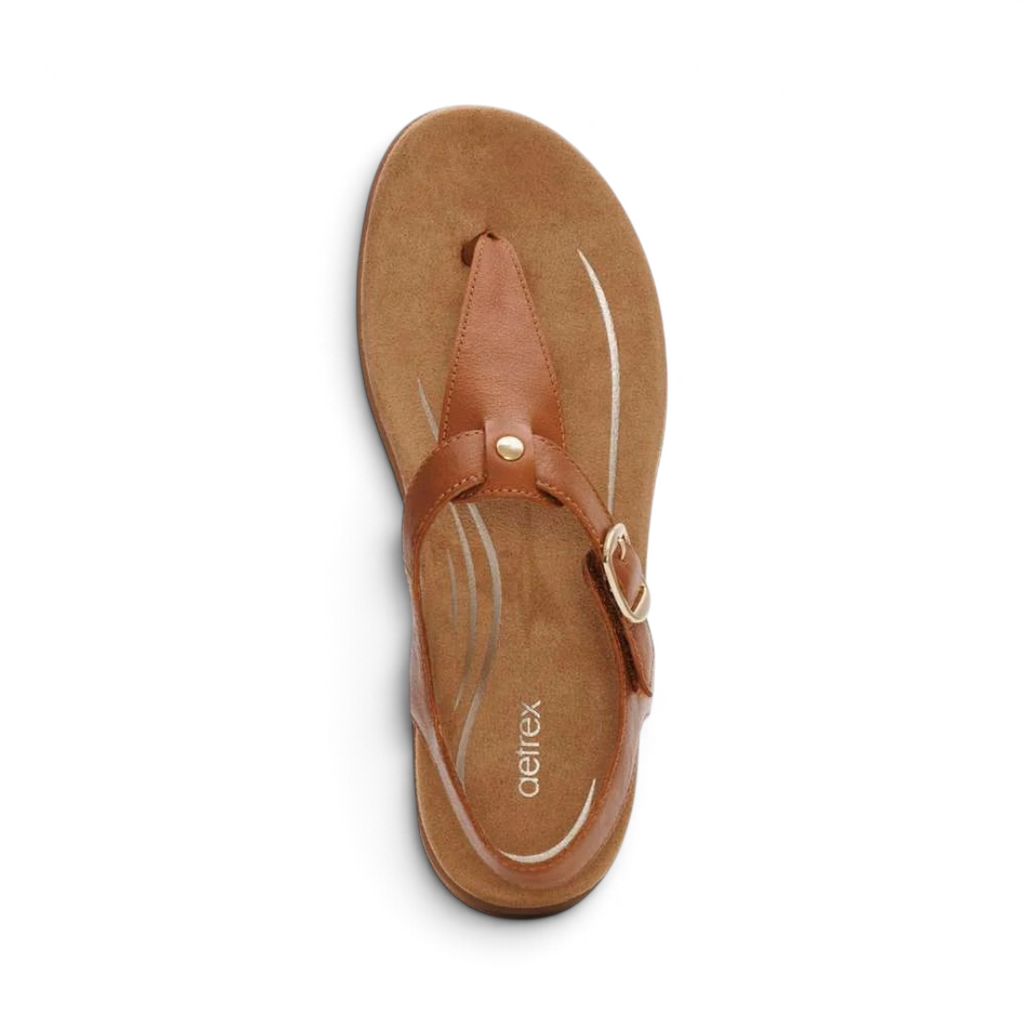 The Happy Shoe Shop Aetrex Tracey brown leather thong sandal with memory foam footbed and adjustable strap.