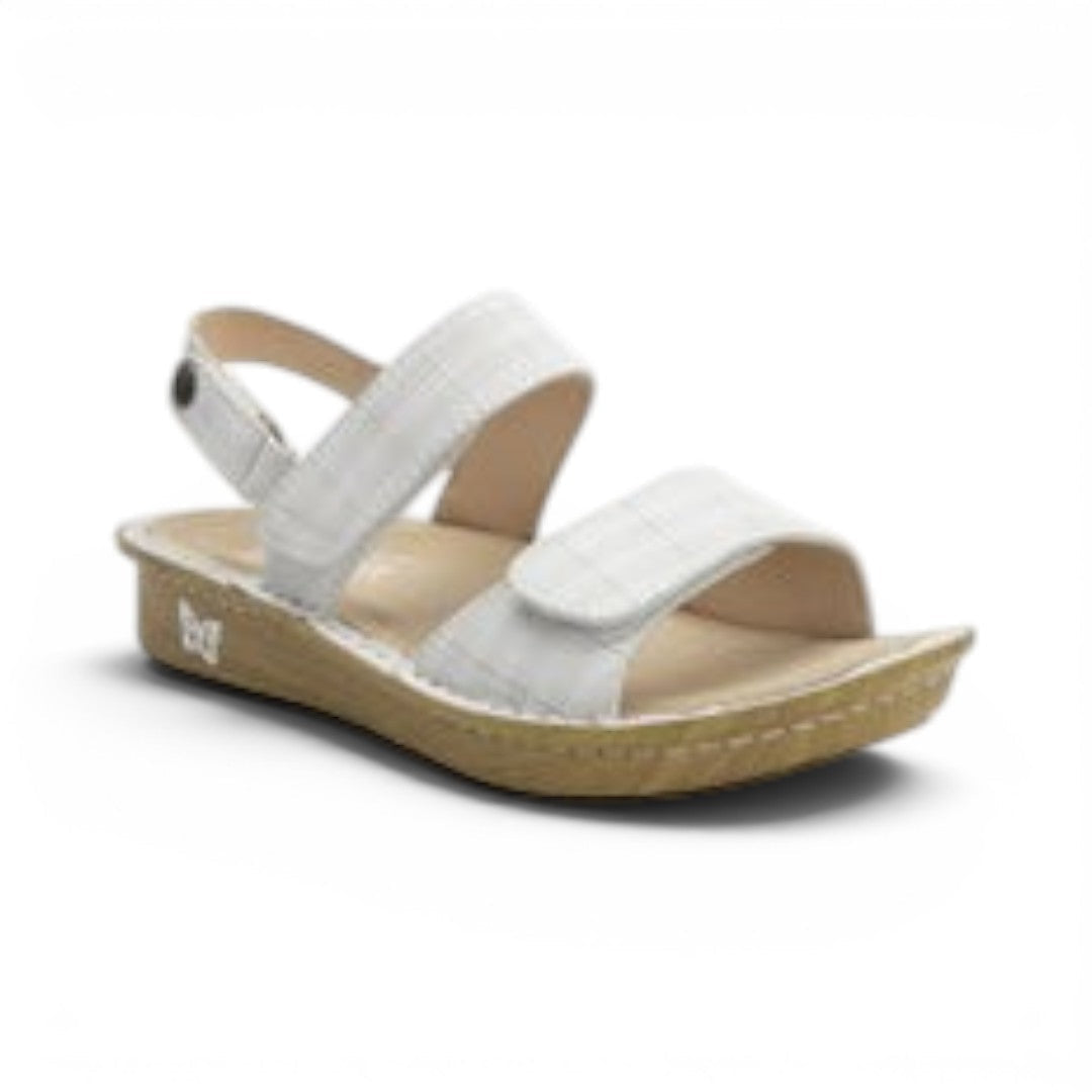The Happy Shoe Shop Alegria Verona sandal in white Engraver pattern leather with adjustable hook-and-loop straps.