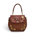 The Happy Shoe Shop Vendula London amber wicker basket bag with sunflower embroidery and hedgehog appliqué details.