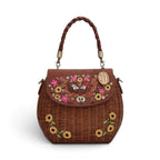 The Happy Shoe Shop Vendula London amber wicker basket bag with sunflower embroidery and hedgehog appliqué details.