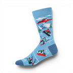 The Happy Shoe Shop Men's Snow Escape bamboo socks in sky blue with skiers, snowboarders, and a red helicopter.