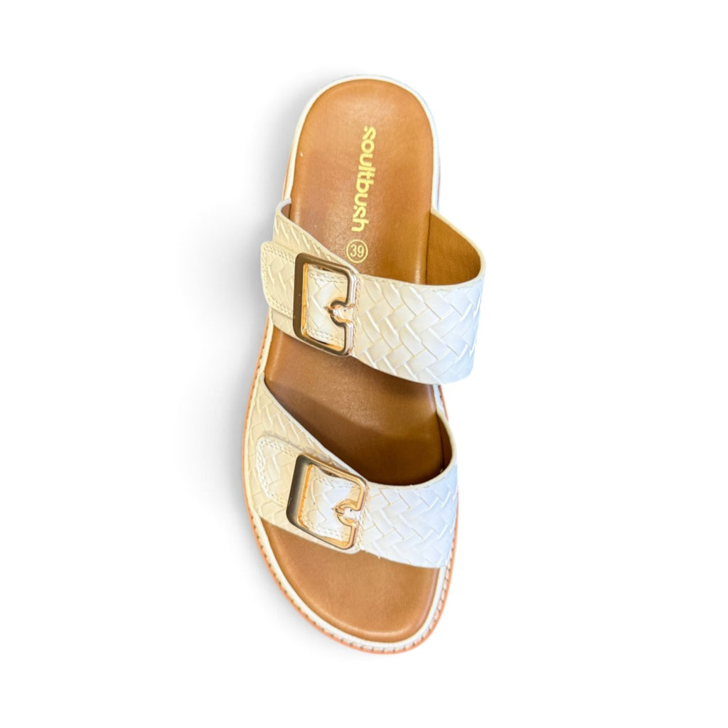 The Happy Shoe Shop Soultbush Mission Sandal in bone with woven leather-look straps and adjustable gold buckles.