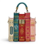 The Happy Shoe Shop Bookshelf Boulevard Book Stack Box Bag, a novelty handbag designed as a stack of classic books in red, teal, pink, and cream vegan leather.