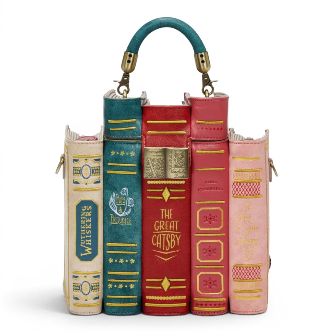 The Happy Shoe Shop Bookshelf Boulevard Book Stack Box Bag, a novelty handbag designed as a stack of classic books in red, teal, pink, and cream vegan leather.