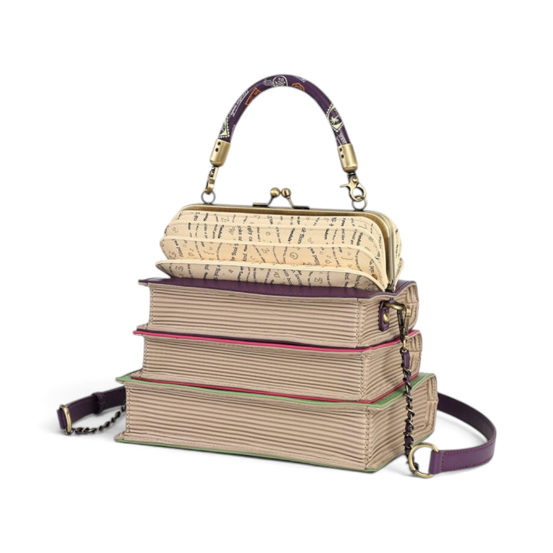 The Happy Shoe Shop Vendula London book stack handbag in vegan leather with a clip-frame opening and purple handle.
