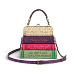 The Happy Shoe Shop Vendula London book stack handbag in purple, pink, and green vegan leather with a crossbody strap.