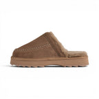 The Happy Shoe Shop Emu Sharky Slide in brown suede with plush sheepskin lining and a distinctive serrated sole.