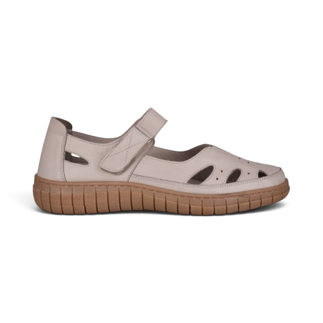 The Happy Shoe Shop Cabello Rise beige leather Mary Jane shoe with cut-out details, Velcro strap, and rubber sole.