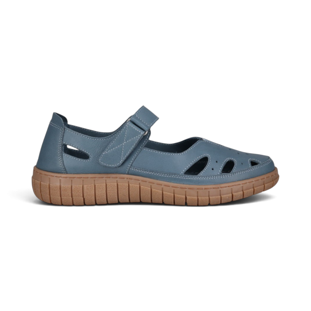 The Happy Shoe Shop Cabello Rise blue leather Mary Jane shoe with cut-outs, Velcro strap, and brown rubber sole.