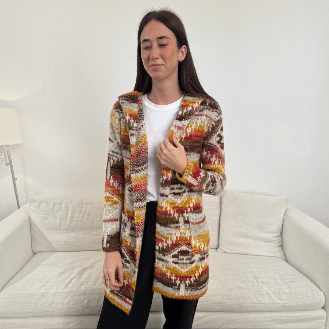 The Happy Shoe Shop Cinnamon Creations knitted hooded cardigan with a vibrant autumnal maple leaf geometric pattern.