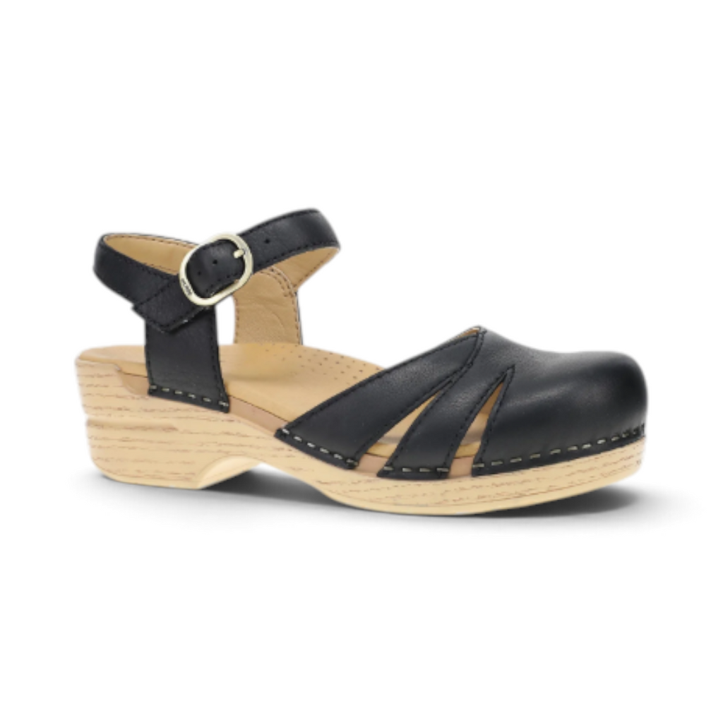 The Happy Shoe Shop Dansko Margreta black leather Mary Jane clog with cutout details and a wood-look rocker sole.
