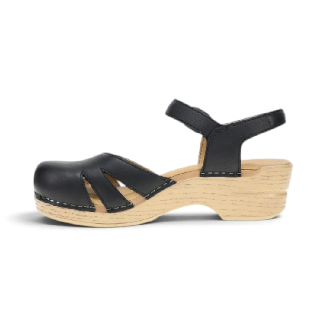 The Happy Shoe Shop Dansko Margreta black leather Mary Jane clog with cut-out details and a light wood-look rocker sole