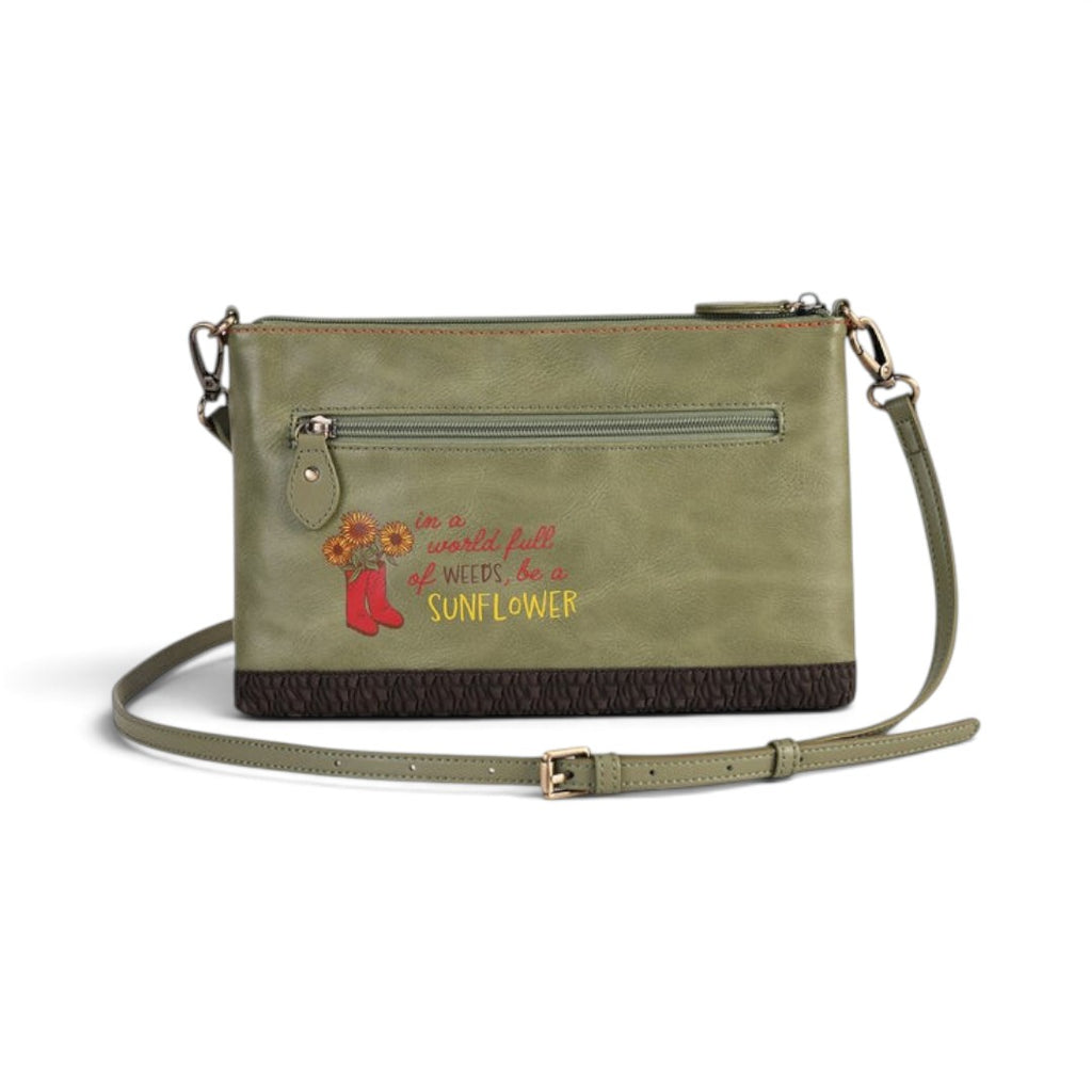 The Happy Shoe Shop Vendula London green vegan leather crossbody bag with sunflower embroidery and quote detail.