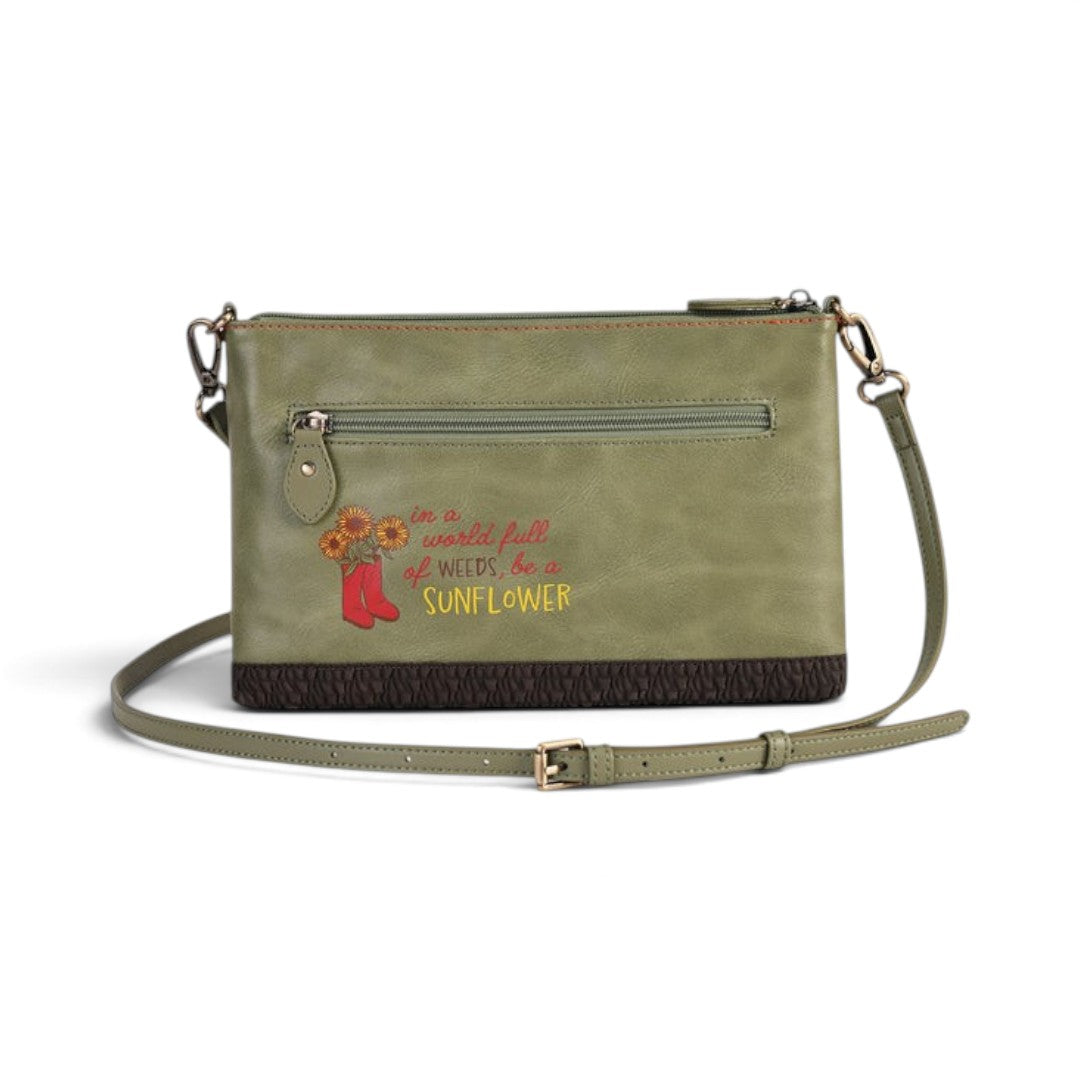 The Happy Shoe Shop Vendula London green vegan leather crossbody bag with sunflower embroidery and quote detail.