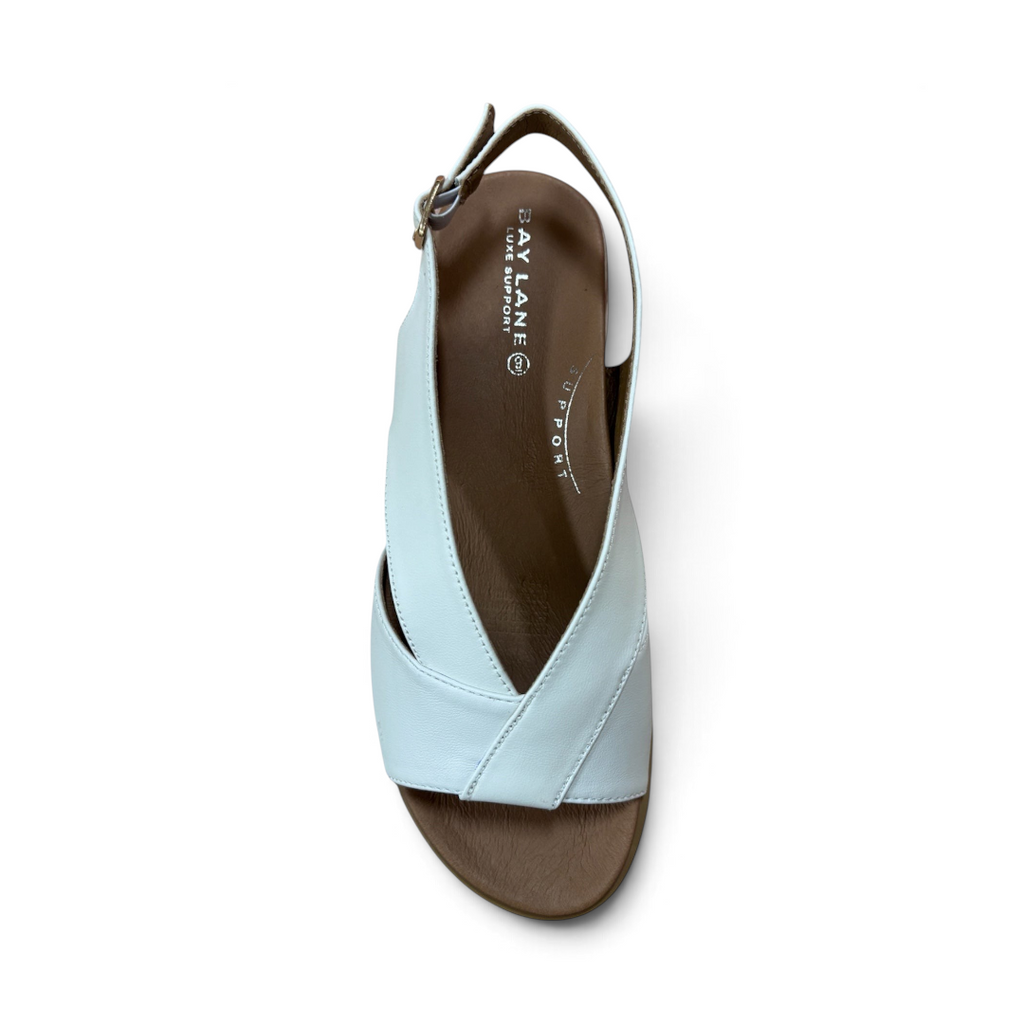 The Happy Shoe Shop Bay Lane Lacey white platform sandals with a criss-cross strap design and cushioned footbed.