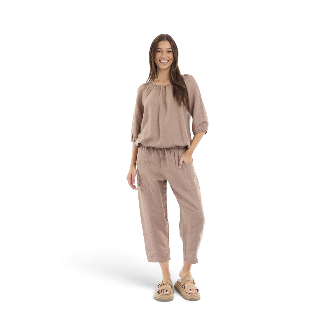 Model wearing The Happy Shoe Shop Orientique Escape linen blend cropped pants in beige with a drawstring waist