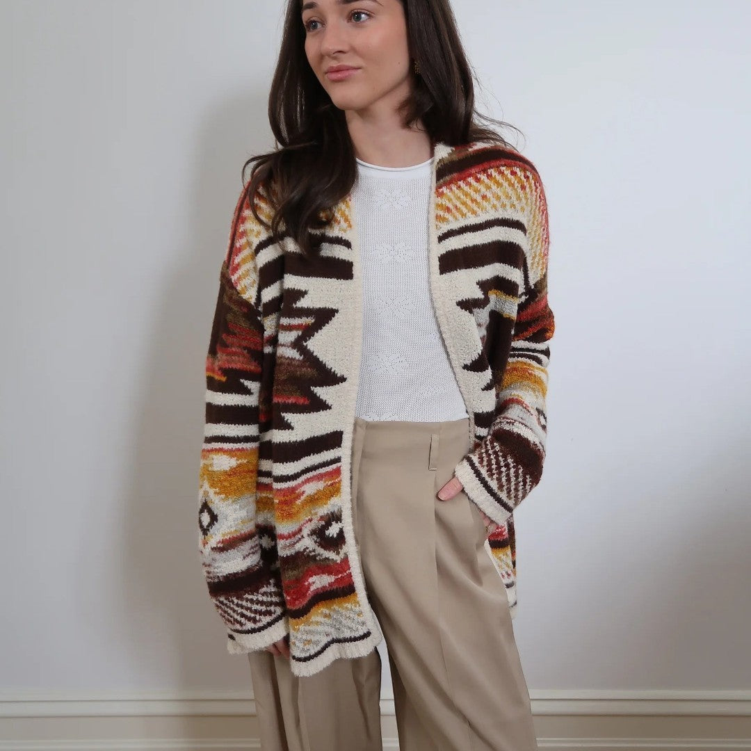 The Happy Shoe Shop Cinnamon Creations maple leaf knitted cardigan with a geometric pattern in warm autumn tones.
