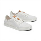 The Happy Shoe Shop Olukai Pehuea Li white mesh lace-up sneakers with tan leather accents and drop-in heel design.
