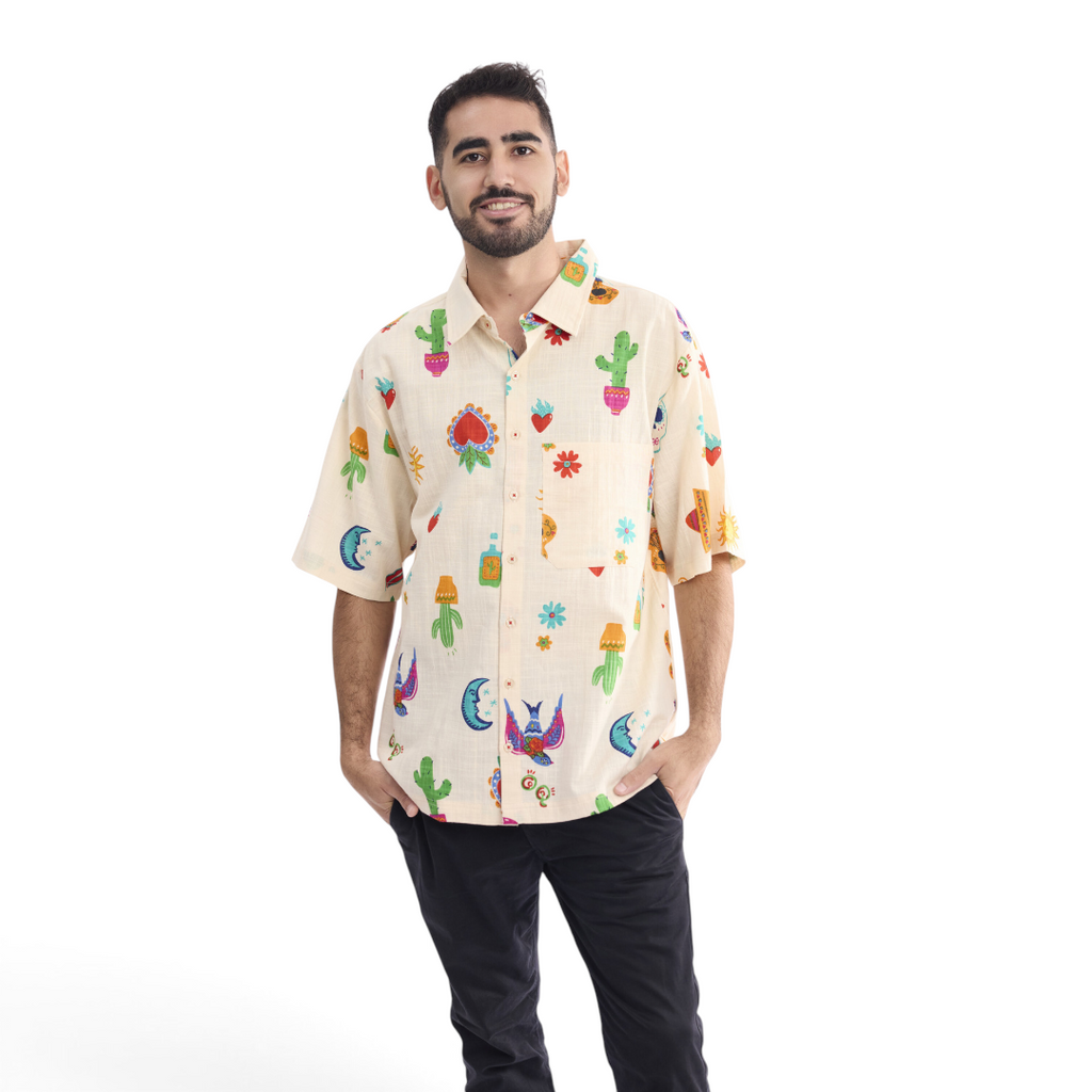 A man wearing a The Happy Shoe Shop Orientique short sleeve shirt with a cream base and colorful cactus print.