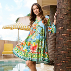 The Happy Shoe Shop Orientique Escape dress with vibrant Mediterranean print, mandarin collar, and tiered rayon skirt.