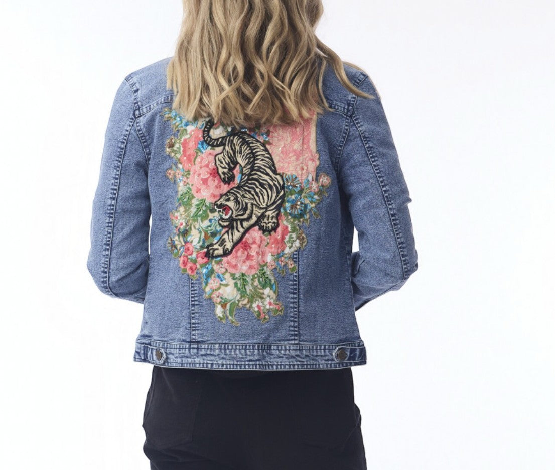 The Happy Shoe Shop Orientique Keqioa denim jacket with back tiger and floral embroidery on a woman.