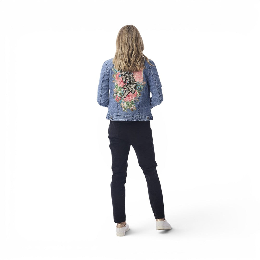 Woman wearing The Happy Shoe Shop Orientique Keqioa denim jacket with tiger and floral back print, white background.