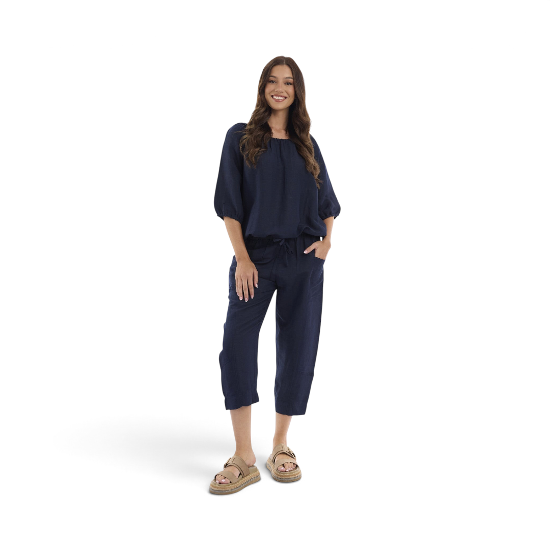 Model wearing The Happy Shoe Shop Orientique Escape navy linen blend cropped culotte pants with a drawstring waist.