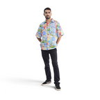Model wearing a The Happy Shoe Shop Orientique short sleeve shirt with a colourful patchwork print in organic cotton.