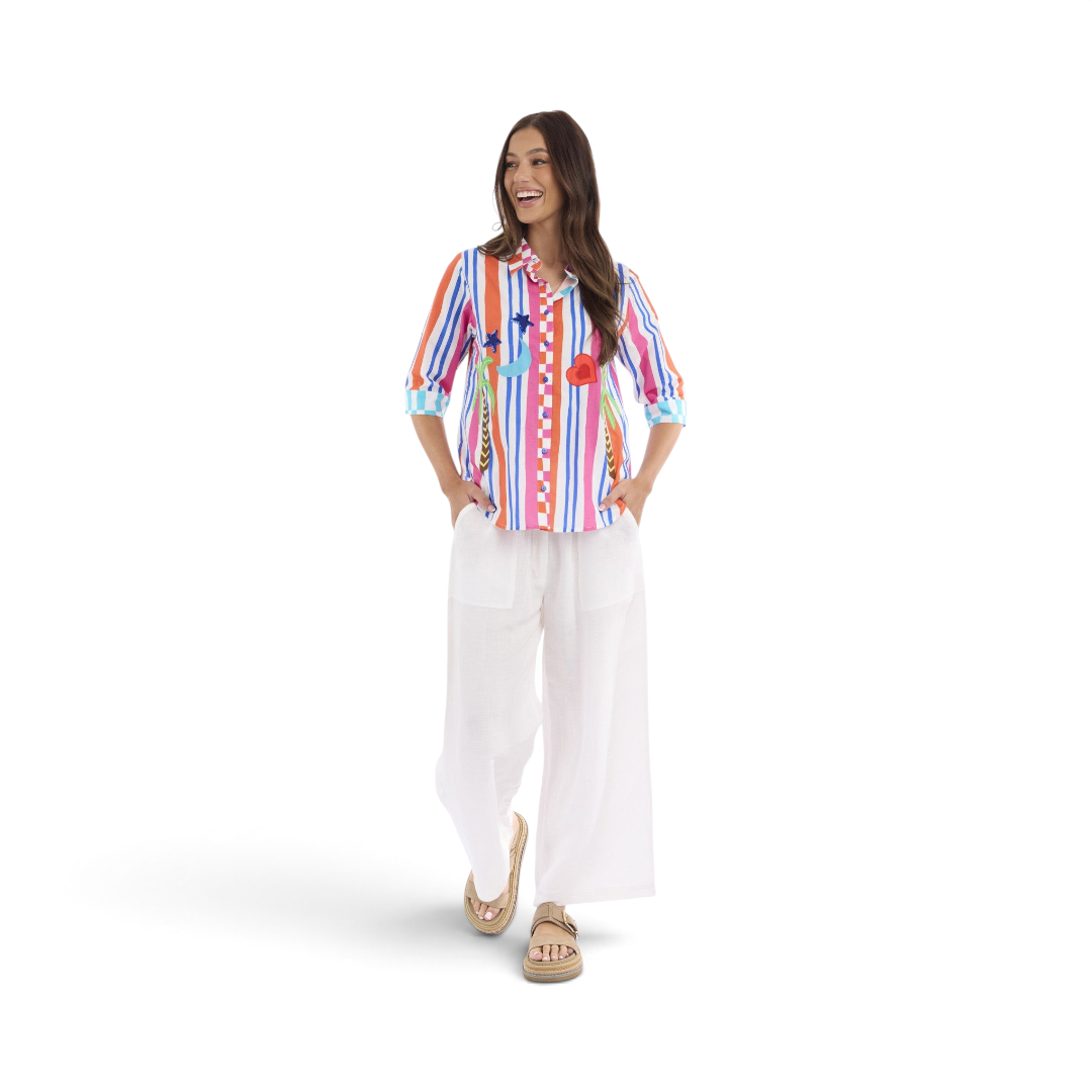 Model wearing The Happy Shoe Shop Orientique Escape Demi Shirt, a multi-colour striped organic cotton button-down top.