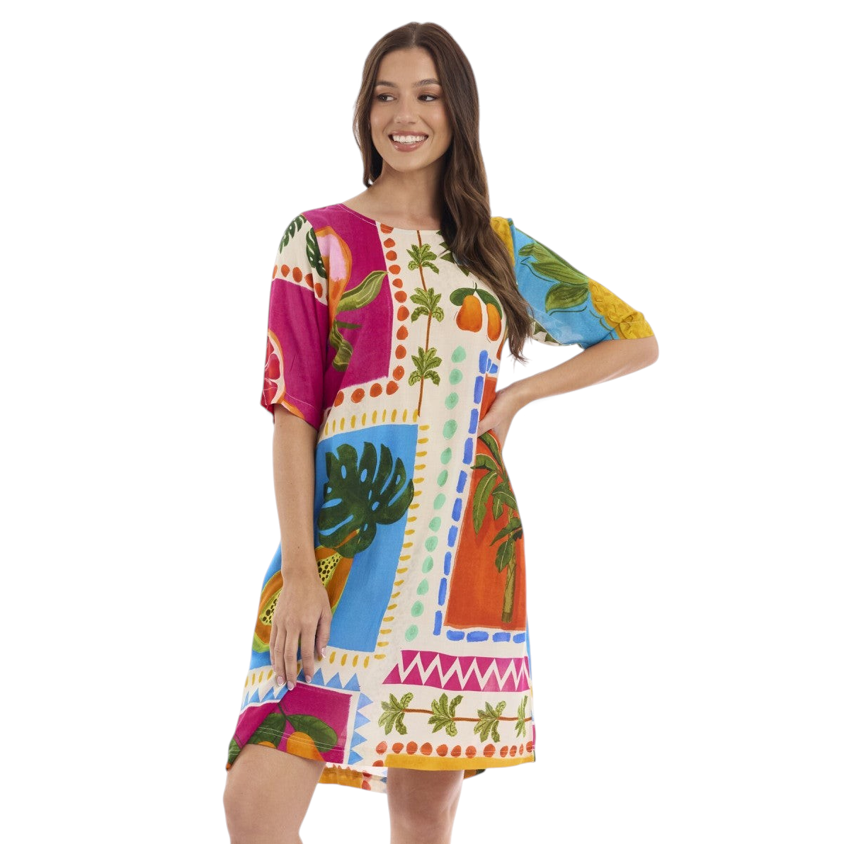 The Happy Shoe Shop model wearing a vibrant, multi-colored Orientique rayon tunic dress with tropical print.