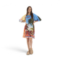 Model wearing The Happy Shoe Shop Orientique Escape Gloria rayon dress with tropical palm tree print and puff sleeves