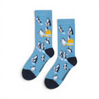 The Happy Shoe Shop unisex blue bamboo socks with a penguin and sunset pattern. Made from 80% bamboo.