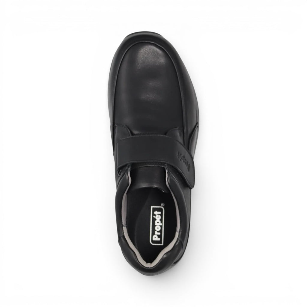 The Happy Shoe Shop Propet black leather men's shoe with adjustable velcro strap and cushioned sole.