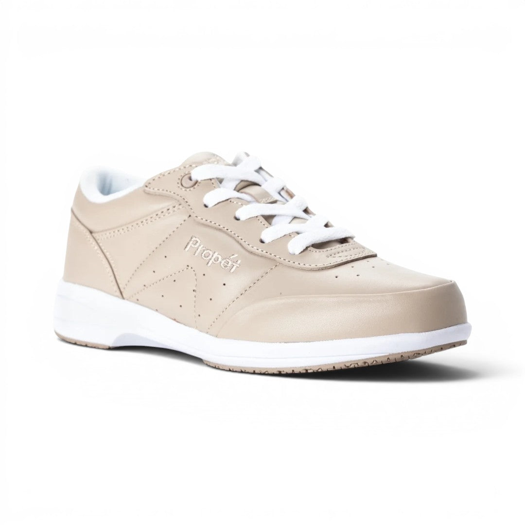 The Happy Shoe Shop Propet Washable Walker in beige leather with white laces and a white sole. Features perforations and stitching details.