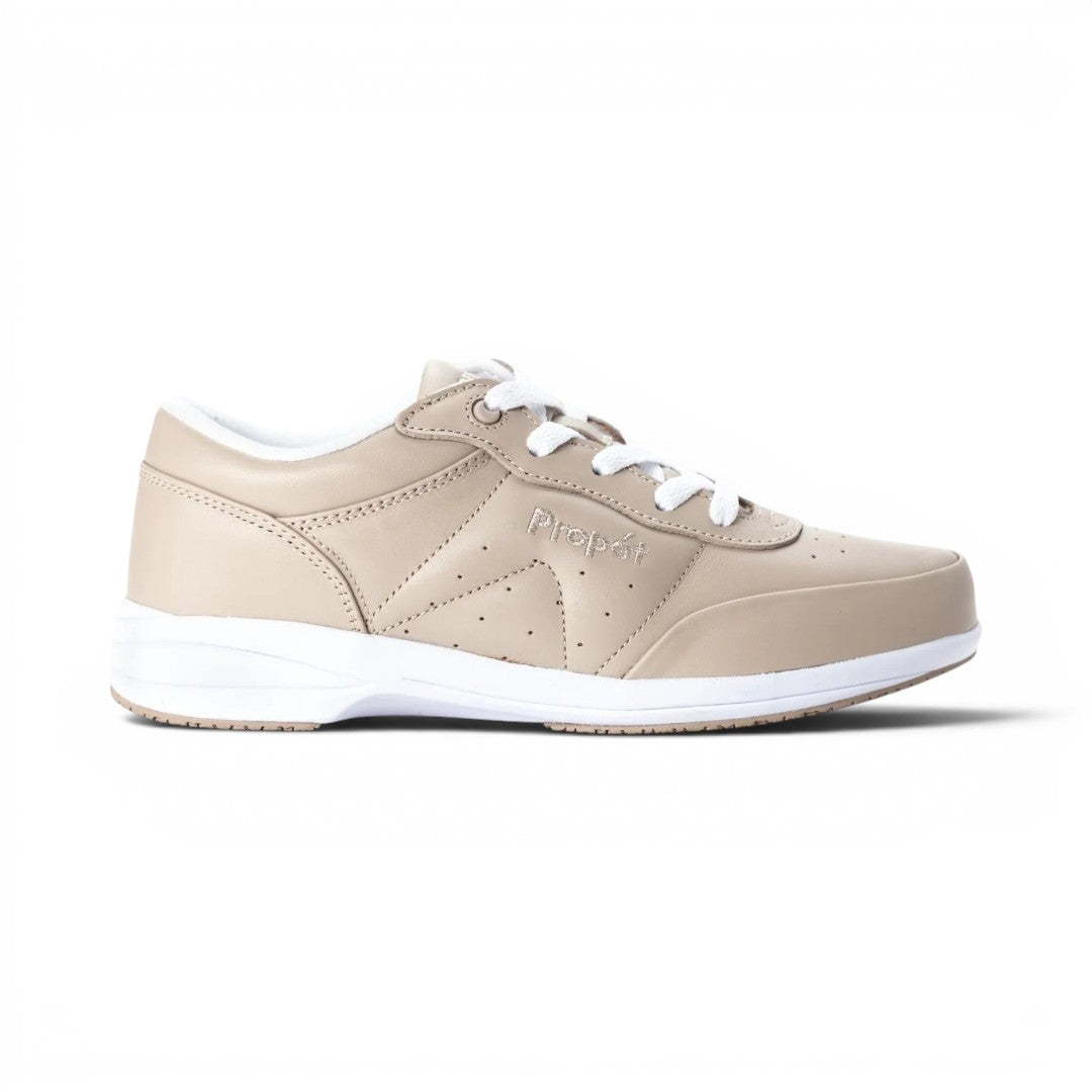 The Happy Shoe Shop Propet Washable Walker women's beige leather sneakers with white laces and soles. Features perforated details and a low-top design.