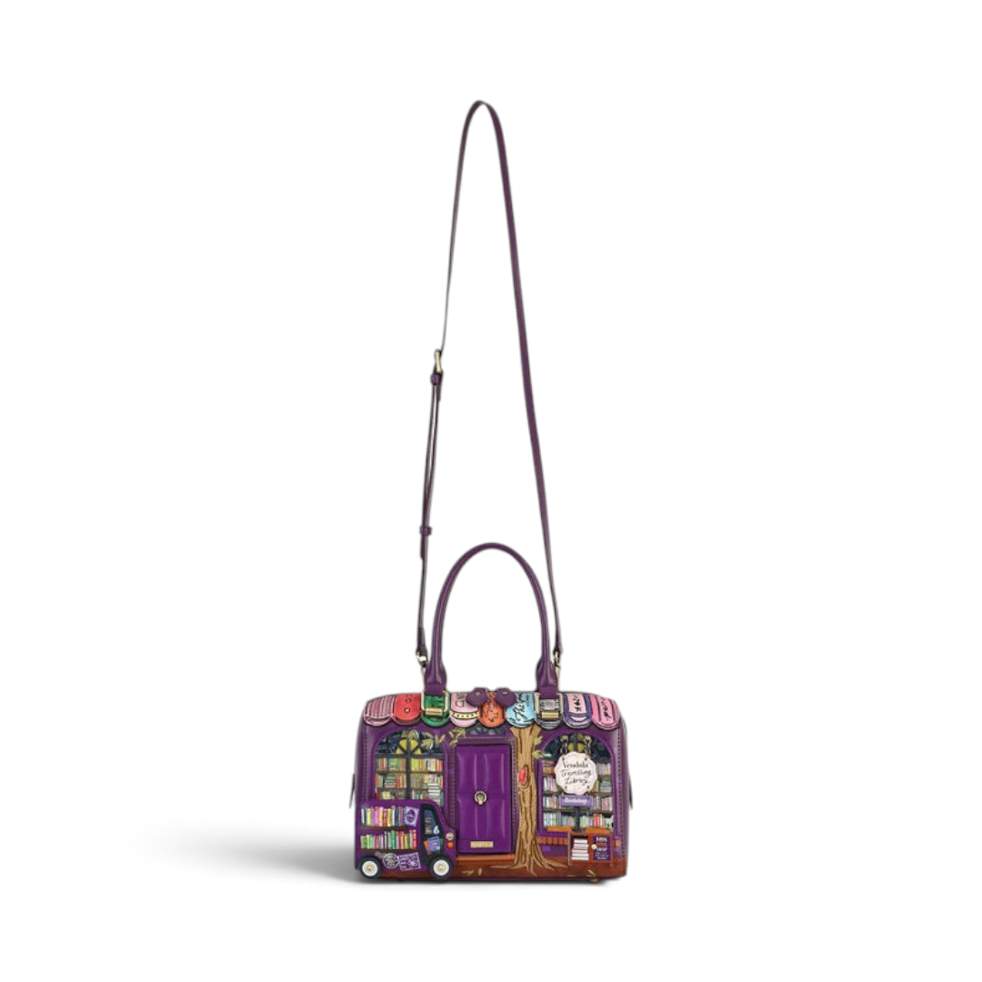 The Happy Shoe Shop Vendula London purple vegan leather bowler bag featuring a whimsical bookshop scene and strap.