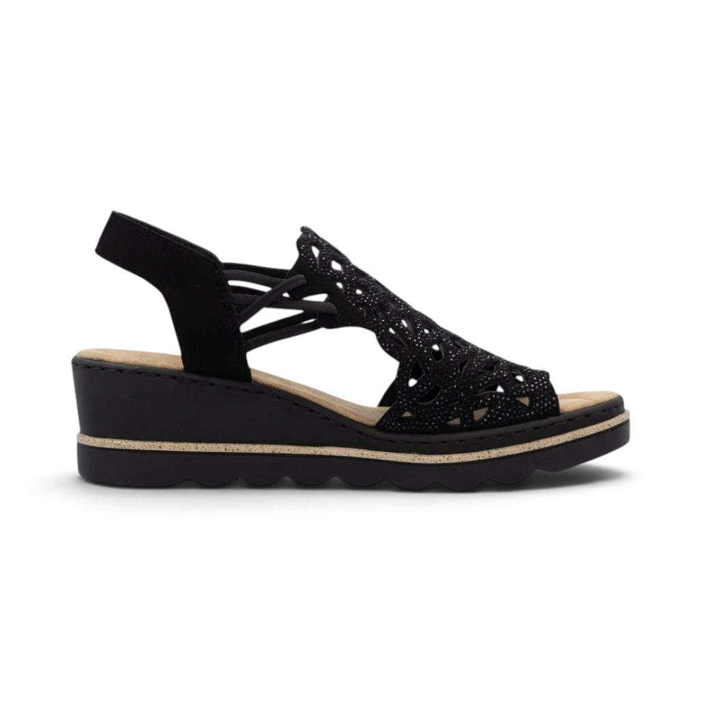 The Happy Shoe Shop Rieker 67465 black wedge sandal with intricate cut-out textile upper and cushioned insole.