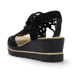 The Happy Shoe Shop Rieker black wedge sandal with intricate cut-out textile upper and cushioned insole