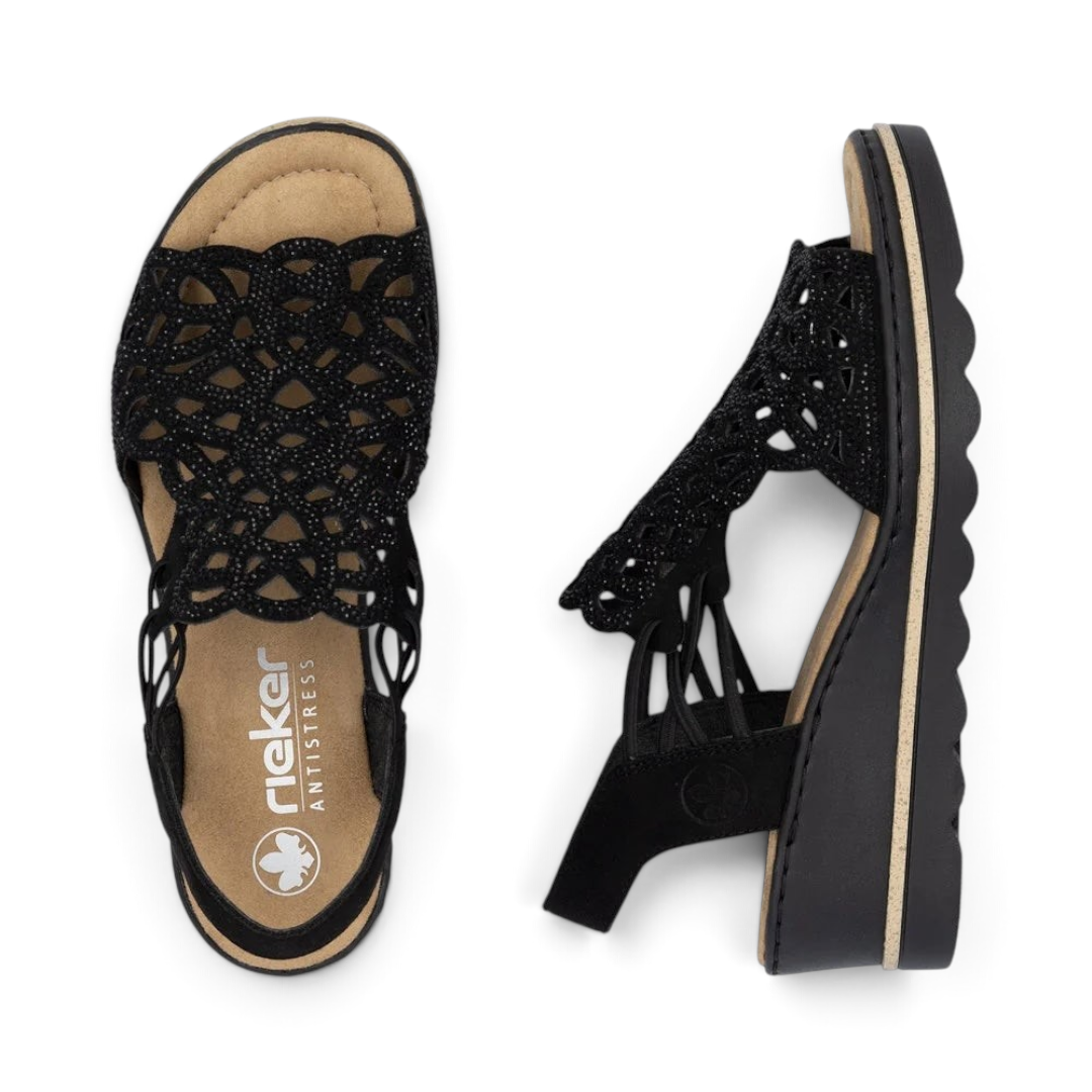 The Happy Shoe Shop Rieker 67465 black wedge sandals with intricate cut-out textile upper and cushioned insole.