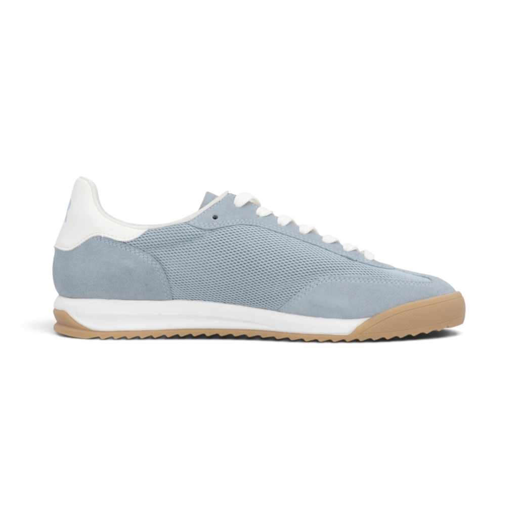 The Happy Shoe Shop Rieker blue textile sneakers with white laces and a gum rubber outsole, side view.