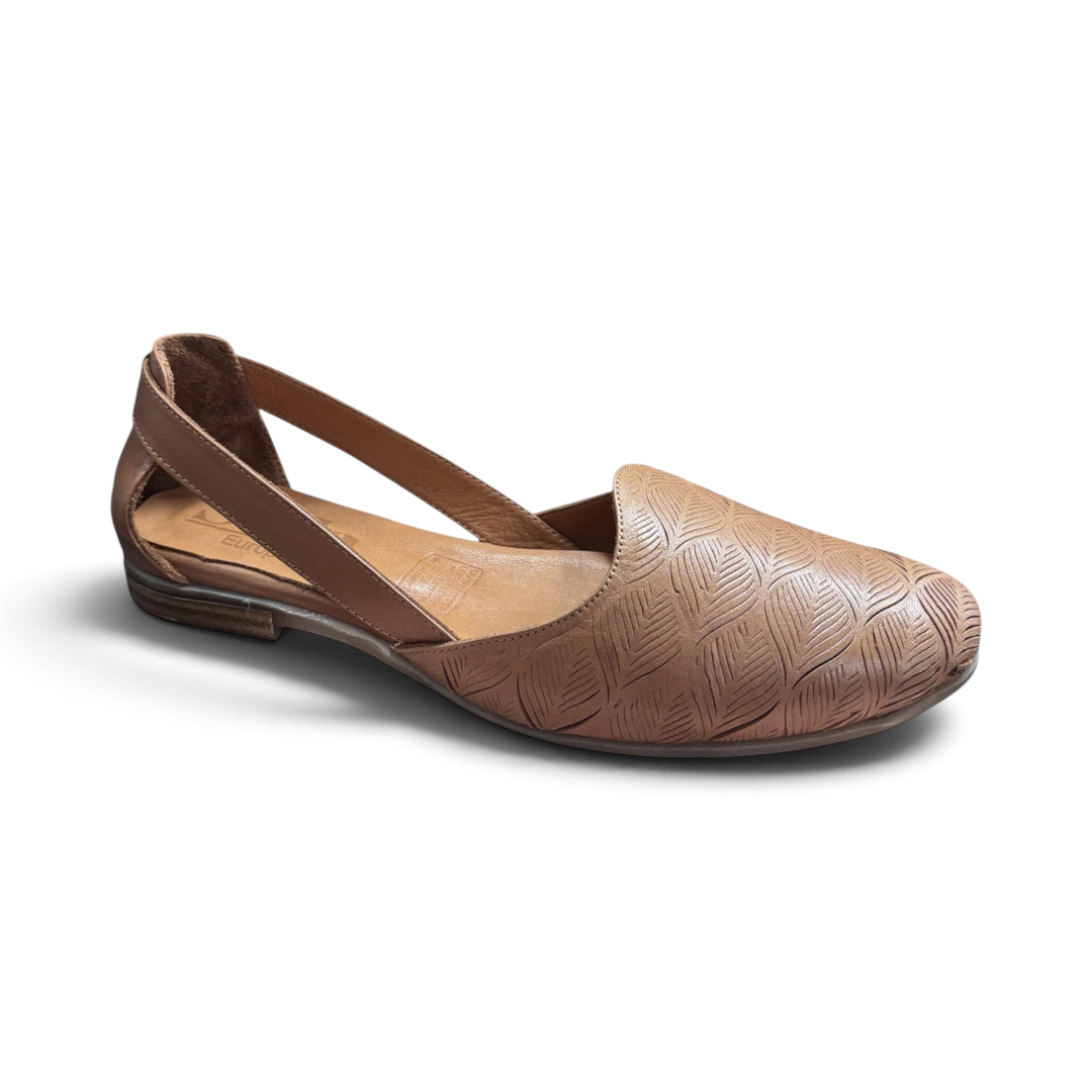 The Happy Shoe Shop Sala Cresta tan leather flat with intricate laser-cut leaf pattern and side cut-out design.