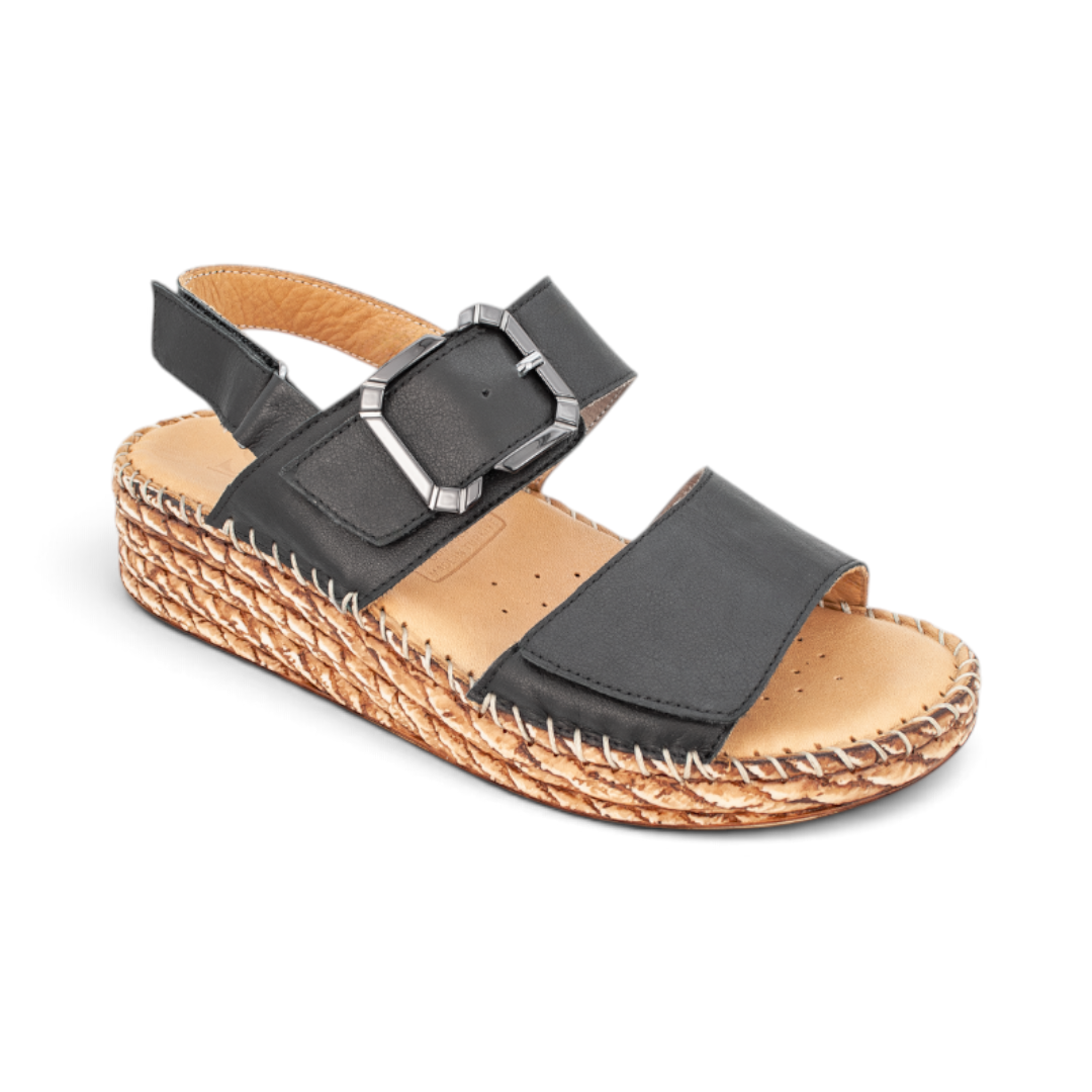 The Happy Shoe Shop Sala Manitu black leather wedge sandal with adjustable buckle strap and woven platform sole.
