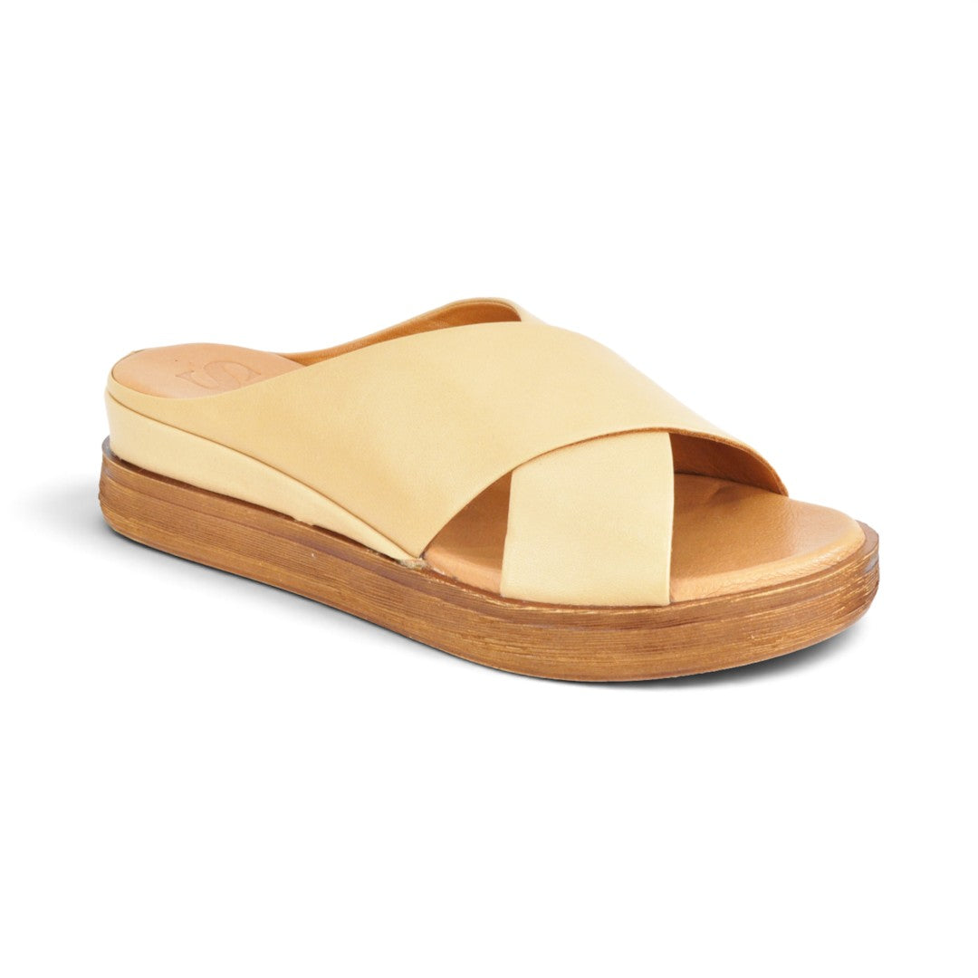 The Happy Shoe Shop Sala Posie slides in beige leather with a comfortable low wedge heel and cross-strap design.