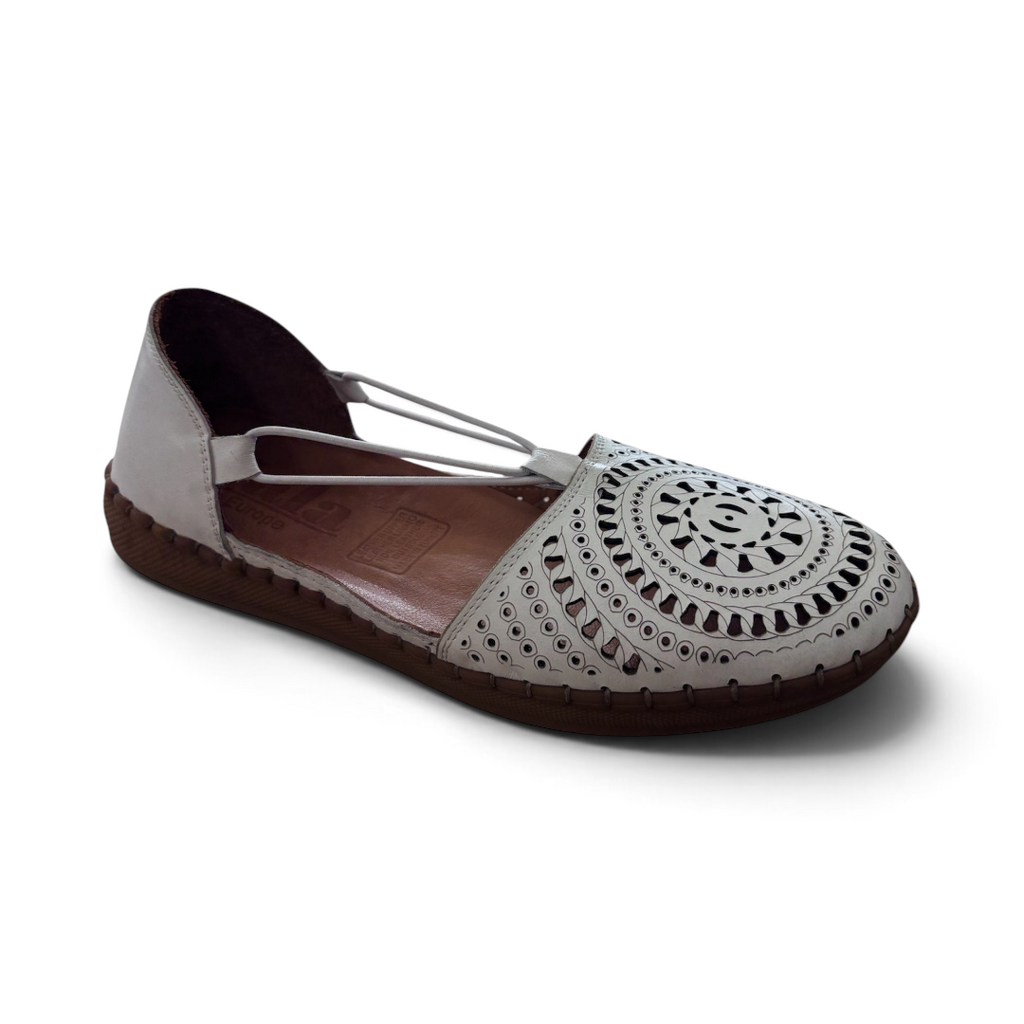 The Happy Shoe Shop Sala Reed flats in white leather with intricate laser-cut circular patterns and a brown sole.