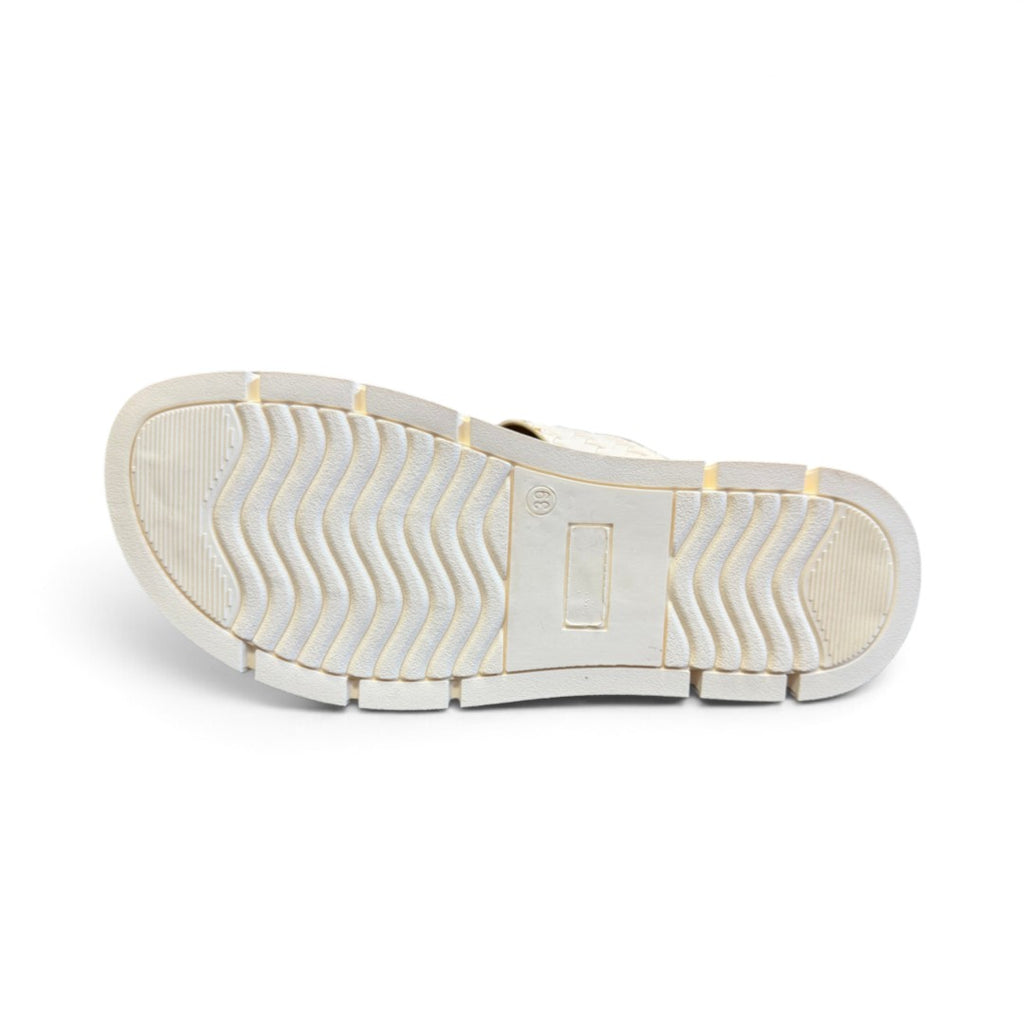 The Happy Shoe Shop Soultbush Mission sandal in bone, showing the textured wavy tread pattern on the white sole.