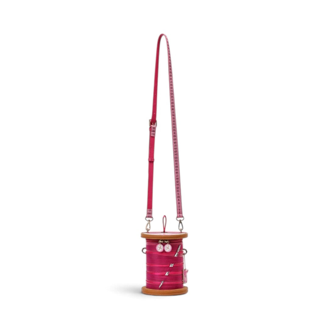 The Happy Shoe Shop Vendula London sewing box scrapbook reel bag in raspberry vegan leather with measuring tape strap.
