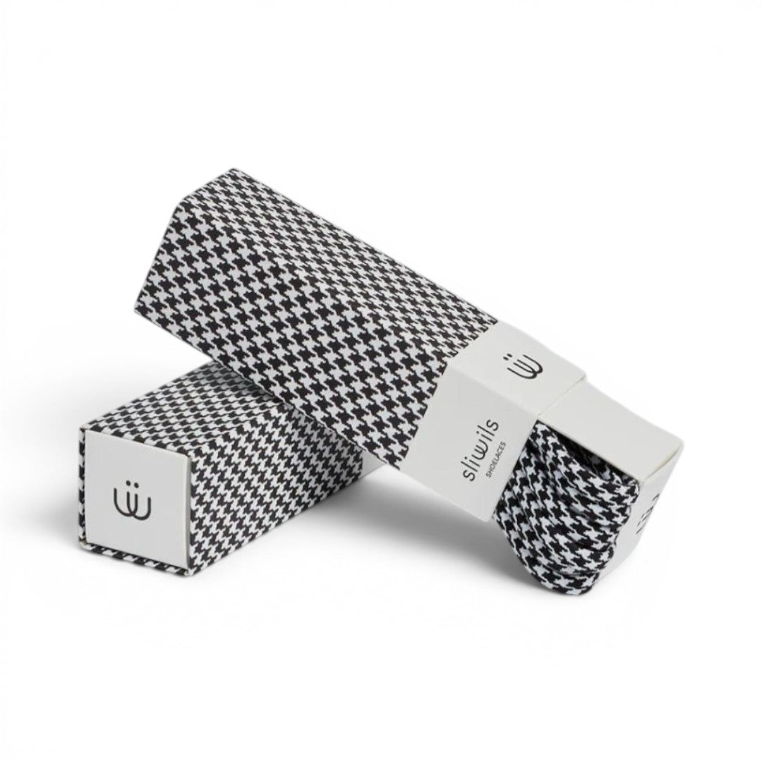 The Happy Shoe Shop Sliwils 120cm shoelaces in a black and white houndstooth pattern inside premium gift packaging.